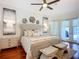 Bright bedroom with hardwood floors, lots of light, and a comfy-looking king-sized bed at 119 Creek Se Dr, Port Charlotte, FL 33952
