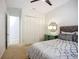 Cozy bedroom featuring a comfortable bed, closet and decorative mirror at 119 Creek Se Dr, Port Charlotte, FL 33952