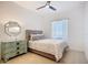 Cozy bedroom featuring a comfortable bed, decorative mirror and large window at 119 Creek Se Dr, Port Charlotte, FL 33952
