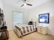 Bright bedroom features a comfortable bed with a decorative shelf and large window at 119 Creek Se Dr, Port Charlotte, FL 33952