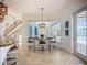 Dining area with modern light fixture and chairs with views of the backyard and pool at 119 Creek Se Dr, Port Charlotte, FL 33952