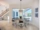Dining area with modern table set featuring an ornate light fixture and access to the outdoors at 119 Creek Se Dr, Port Charlotte, FL 33952