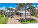 Beautiful home with a large brick driveway, lush landscaping and a two-car garage at 119 Creek Se Dr, Port Charlotte, FL 33952