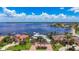 An aerial view of a stunning waterfront home with palm trees and a brick driveway at 119 Creek Se Dr, Port Charlotte, FL 33952