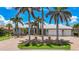 Stunning home with a spacious two-car garage, lush landscaping, and brick driveway at 119 Creek Se Dr, Port Charlotte, FL 33952