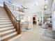 Spacious foyer featuring high ceilings, staircase, and views of the living spaces at 119 Creek Se Dr, Port Charlotte, FL 33952