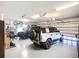 Spacious three car garage with high ceilings and a ceiling fan provides parking and extra storage at 119 Creek Se Dr, Port Charlotte, FL 33952
