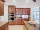 This kitchen has a center island, stainless steel appliances, and custom cabinets for ample storage at 119 Creek Se Dr, Port Charlotte, FL 33952