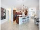Open-concept kitchen features dark wood cabinets, granite counters, and counter seating at 119 Creek Se Dr, Port Charlotte, FL 33952
