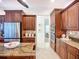 This kitchen has stainless steel appliances, a center island, custom cabinets, and granite countertops at 119 Creek Se Dr, Port Charlotte, FL 33952
