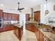 Gourmet kitchen boasts custom cabinets, granite countertops, tiled backsplash, and stainless steel appliances at 119 Creek Se Dr, Port Charlotte, FL 33952