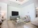 Bright living room showcasing a decorative console, stylish clock, and comfortable seating arrangement at 119 Creek Se Dr, Port Charlotte, FL 33952