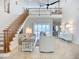 Bright living room with vaulted ceilings, staircase and water views from large windows at 119 Creek Se Dr, Port Charlotte, FL 33952
