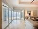 Bright living room showcasing sliding glass doors leading to an outdoor waterfront patio at 119 Creek Se Dr, Port Charlotte, FL 33952