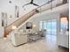 Bright living room with soaring ceilings, sleek tile flooring and sliding glass doors to pool at 119 Creek Se Dr, Port Charlotte, FL 33952