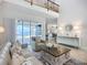 Open living room with modern decor, neutral finishes and sliding glass doors to outdoor living space at 119 Creek Se Dr, Port Charlotte, FL 33952