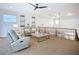 Cozy loft area featuring neutral decor, railing, and a ceiling fan at 119 Creek Se Dr, Port Charlotte, FL 33952
