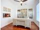 Well-lit office featuring a large desk, hardwood floors, and stylish wall decor at 119 Creek Se Dr, Port Charlotte, FL 33952