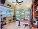 Office space features a large desk, built-in shelving and beautiful backyard water views at 119 Creek Se Dr, Port Charlotte, FL 33952