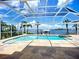 Inviting screened-in pool and spa with a tranquil waterfront view, perfect for relaxation at 119 Creek Se Dr, Port Charlotte, FL 33952