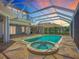 A serene screened pool and spa with a covered patio, ideal for leisure and outdoor enjoyment at 119 Creek Se Dr, Port Charlotte, FL 33952