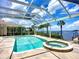 A serene screened-in pool and spa with a beautiful waterfront view, perfect for relaxation and enjoyment at 119 Creek Se Dr, Port Charlotte, FL 33952
