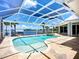 Inviting screened-in pool area with a tranquil waterfront view, perfect for relaxation and entertaining at 119 Creek Se Dr, Port Charlotte, FL 33952