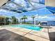 Inviting screened-in pool and spa with a tranquil waterfront view, perfect for relaxation at 119 Creek Se Dr, Port Charlotte, FL 33952