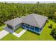 Aerial view of a well-maintained home with a large lot, beautiful landscaping, and a spacious driveway at 12300 El Prado Dr, Punta Gorda, FL 33955