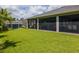 Large backyard with well-kept lawn, screened-in porch and a storage shed at 12300 El Prado Dr, Punta Gorda, FL 33955