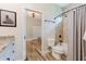 Beautiful bathroom featuring a tub/shower combo, light countertops, and stylish wood-look tile floors at 12300 El Prado Dr, Punta Gorda, FL 33955