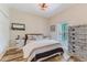 Comfortable bedroom featuring wood-look tile floors, natural light, and neutral paint at 12300 El Prado Dr, Punta Gorda, FL 33955