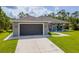 Charming single-story home with a spacious driveway and well-manicured lawn at 12300 El Prado Dr, Punta Gorda, FL 33955