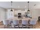 Bright, modern kitchen featuring stainless steel appliances, granite countertops, and island seating at 12300 El Prado Dr, Punta Gorda, FL 33955
