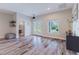 Bright living room featuring wood-look tile flooring, neutral paint, and a view of the front yard at 12300 El Prado Dr, Punta Gorda, FL 33955