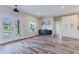 Spacious living room featuring stylish wood-look tile flooring, neutral paint, and plenty of natural light at 12300 El Prado Dr, Punta Gorda, FL 33955