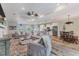 Open-concept living area with wood floors, modern furnishings, and a seamless flow to the kitchen at 12300 El Prado Dr, Punta Gorda, FL 33955
