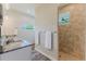 Luxurious main bathroom with double sinks, granite countertops, and a tiled walk-in shower at 12300 El Prado Dr, Punta Gorda, FL 33955