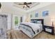 Serene main bedroom with tray ceiling, natural light, and a view to the back yard at 12300 El Prado Dr, Punta Gorda, FL 33955
