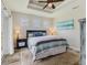 Cozy main bedroom with tray ceilings, carpet, and three windows for natural light at 12300 El Prado Dr, Punta Gorda, FL 33955
