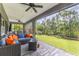 Relaxing screened-in porch area with stylish wicker furniture and views of the lush green backyard at 12300 El Prado Dr, Punta Gorda, FL 33955