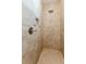 Modern walk-in shower featuring elegant tile, a rainfall showerhead, and a built-in niche at 12300 El Prado Dr, Punta Gorda, FL 33955
