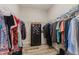 Well-organized walk-in closet with ample hanging space, shelving, and a personal safe at 12300 El Prado Dr, Punta Gorda, FL 33955