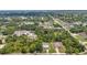 A high aerial showcases a neighborhood's layout amid lush trees, providing privacy and a sense of community at 1242 Orlando Blvd, Port Charlotte, FL 33952