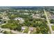 A broad aerial view showcases a neighborhood nestled among lush trees, blending privacy with community connections at 1242 Orlando Blvd, Port Charlotte, FL 33952