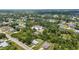 A wide aerial perspective reveals a tranquil neighborhood embraced by lush trees, offering seclusion and community spirit at 1242 Orlando Blvd, Port Charlotte, FL 33952