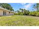 The backyard offers ample room and a view of surrounding greenery at 1242 Orlando Blvd, Port Charlotte, FL 33952