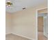 This bedroom features light tile floors and a doorframe that leads to the hallway at 1242 Orlando Blvd, Port Charlotte, FL 33952