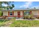 Inviting front entrance with colorful landscaping and charming curb appeal at 1242 Orlando Blvd, Port Charlotte, FL 33952