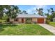 Charming single-story home with an attached garage and a well-maintained lawn at 1242 Orlando Blvd, Port Charlotte, FL 33952
